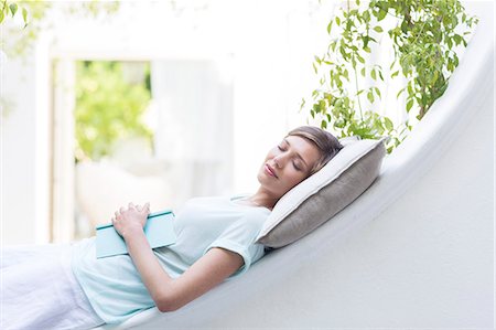 simsearch:6113-07790529,k - Woman relaxing on pillow outdoors Stock Photo - Premium Royalty-Free, Code: 6113-07790562