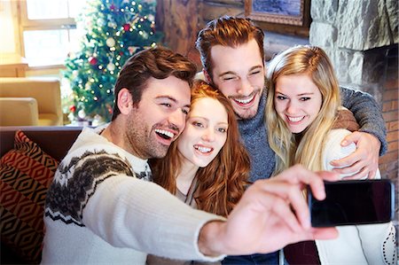 simsearch:649-06716867,k - Friends taking picture together in log cabin Stock Photo - Premium Royalty-Free, Code: 6113-07790593