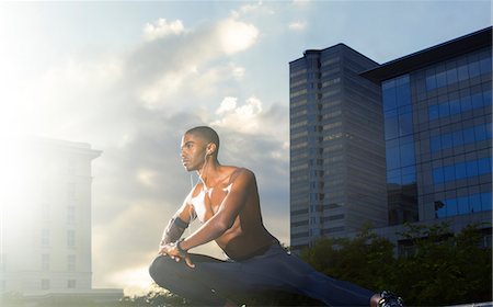 simsearch:6113-07790833,k - Man stretching before exercising on city street Stock Photo - Premium Royalty-Free, Code: 6113-07790777