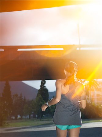 sunny woman outside park - Woman running through city streets Stock Photo - Premium Royalty-Free, Code: 6113-07790796