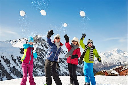 daughter mother strong - Family throwing snowballs on mountain top Stock Photo - Premium Royalty-Free, Code: 6113-07790710