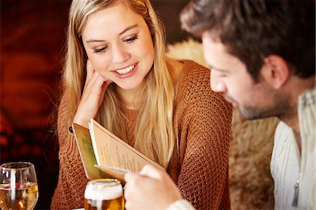 simsearch:6113-07790692,k - Couple looking at restaurant menu together Stock Photo - Premium Royalty-Free, Code: 6113-07790724