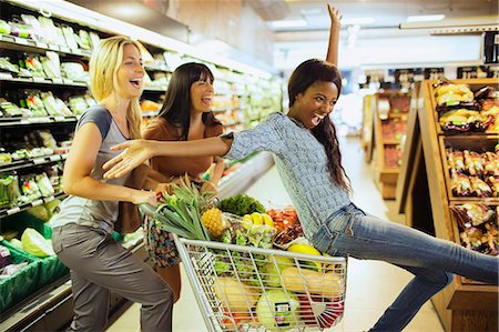 shopping carts - Women playing together in grocery store Stock Photo - Premium Royalty-Free, Code: 6113-07791162