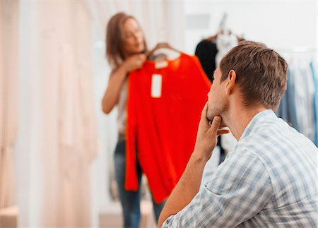 simsearch:6108-05874623,k - Couple shopping together in clothing store Stock Photo - Premium Royalty-Free, Code: 6113-07791191