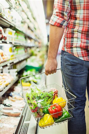 produce grocery store - Man carrying full shopping basket in grocery store Stock Photo - Premium Royalty-Free, Code: 6113-07791118