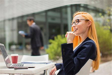 simsearch:6113-07565805,k - Businesswoman working at table outside of office building Stock Photo - Premium Royalty-Free, Code: 6113-07791353
