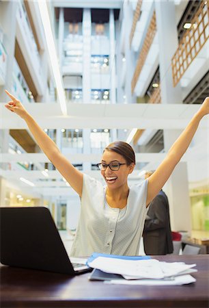 Businesswoman excited while working in office building Stock Photo - Premium Royalty-Free, Code: 6113-07791440