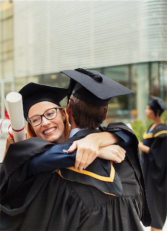 simsearch:6113-07791483,k - Students in cap and gown hugging Stock Photo - Premium Royalty-Free, Code: 6113-07791481