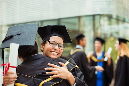 simsearch:6113-07791483,k - Students in cap and gown hugging Stock Photo - Premium Royalty-Free, Code: 6113-07791482