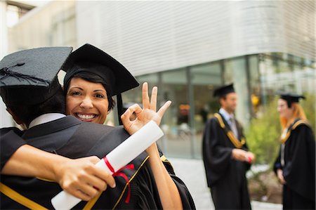 simsearch:6113-07791483,k - Students in cap and gown hugging Stock Photo - Premium Royalty-Free, Code: 6113-07791484