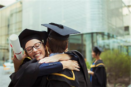 simsearch:6113-07791483,k - Students in cap and gown hugging Stock Photo - Premium Royalty-Free, Code: 6113-07791486