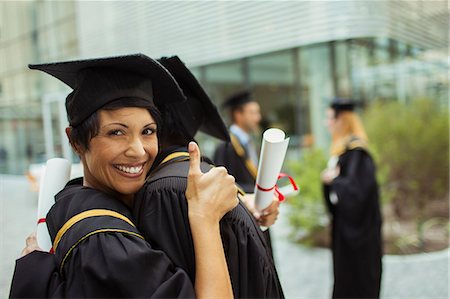 simsearch:6113-07791483,k - Students in cap and gown hugging Stock Photo - Premium Royalty-Free, Code: 6113-07791488