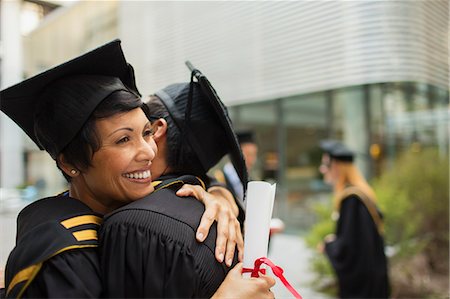 simsearch:6113-07791483,k - Students in cap and gown hugging Stock Photo - Premium Royalty-Free, Code: 6113-07791493