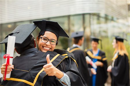 simsearch:6113-07791483,k - Students in cap and gown hugging Stock Photo - Premium Royalty-Free, Code: 6113-07791490