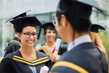 simsearch:6113-07791483,k - Students in cap and gown talking Stock Photo - Premium Royalty-Free, Code: 6113-07791492