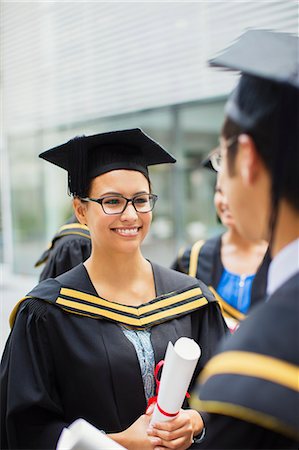 simsearch:6113-07791483,k - Student in cap and gown talking with friends Stock Photo - Premium Royalty-Free, Code: 6113-07791495