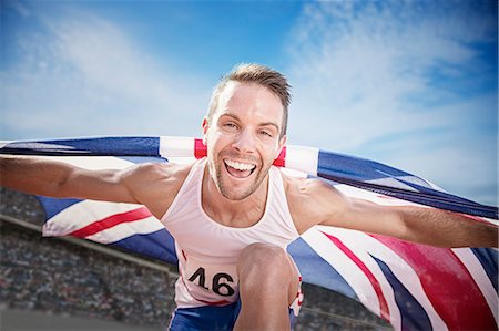 simsearch:6113-07730460,k - Track and field athlete cheering with British flag Stock Photo - Premium Royalty-Free, Code: 6113-07730450