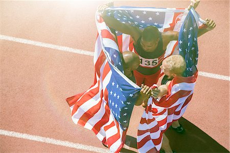 simsearch:6113-07730460,k - Track and field athletes holding American flags on track Stock Photo - Premium Royalty-Free, Code: 6113-07730456