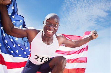 simsearch:6113-07542775,k - Portrait of enthusiastic track and field athlete holding American flag Stock Photo - Premium Royalty-Free, Code: 6113-07730481