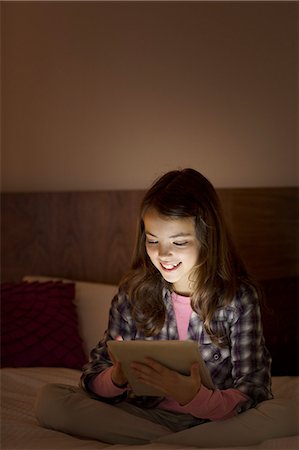 simsearch:6113-06908842,k - Girl using digital tablet on bed Stock Photo - Premium Royalty-Free, Code: 6113-07730586