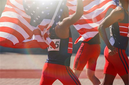 sports events - Track and field athletes holding American flags on track Photographie de stock - Premium Libres de Droits, Code: 6113-07730616