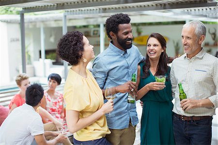 party hugging - Friends talking at party Stock Photo - Premium Royalty-Free, Code: 6113-07730850