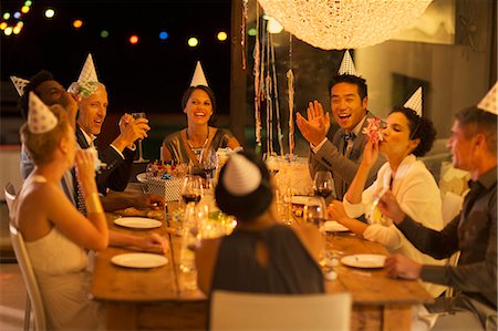 party hat - Friends cheering at birthday party Stock Photo - Premium Royalty-Free, Code: 6113-07730835