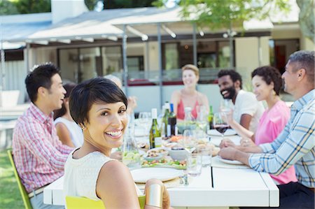 simsearch:6113-07731034,k - Woman smiling at table outdoors Stock Photo - Premium Royalty-Free, Code: 6113-07730945