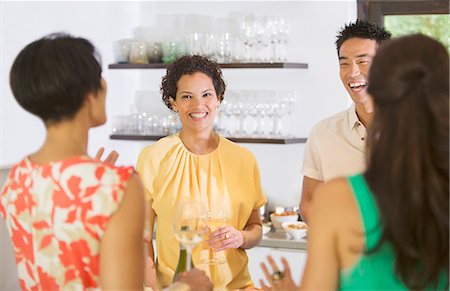 Friends talking at party Stock Photo - Premium Royalty-Free, Code: 6113-07730976