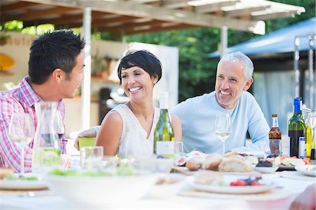 simsearch:6113-07731034,k - Friends relaxing at table outdoors Stock Photo - Premium Royalty-Free, Code: 6113-07730985