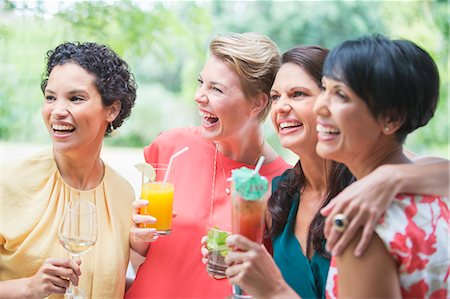 Women smiling together at party Stock Photo - Premium Royalty-Free, Code: 6113-07730988