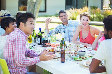 simsearch:6113-07731034,k - Friends talking at table outdoors Stock Photo - Premium Royalty-Free, Code: 6113-07730995