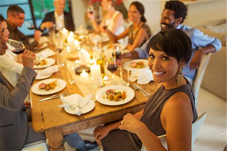 simsearch:6113-07730997,k - Woman smiling at dinner party Foto de stock - Sin royalties Premium, Código: 6113-07730928