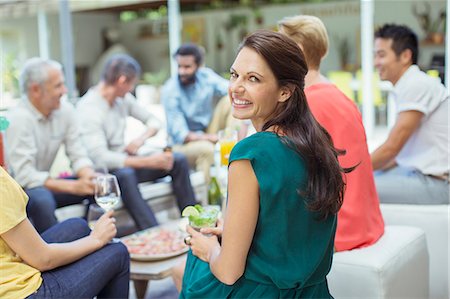 simsearch:6113-07731034,k - Woman smiling at party Stock Photo - Premium Royalty-Free, Code: 6113-07730939