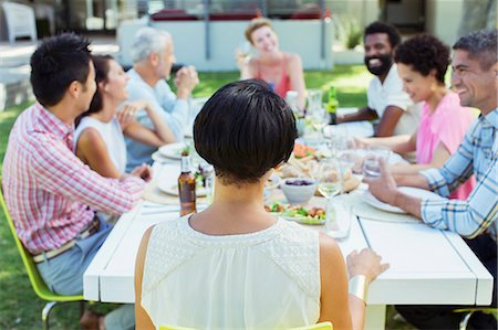 simsearch:6113-07731034,k - Friends talking at table outdoors Stock Photo - Premium Royalty-Free, Code: 6113-07731028