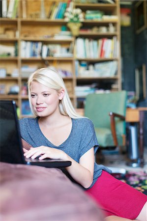 simsearch:6113-07730780,k - Woman using laptop in living room Stock Photo - Premium Royalty-Free, Code: 6113-07731116