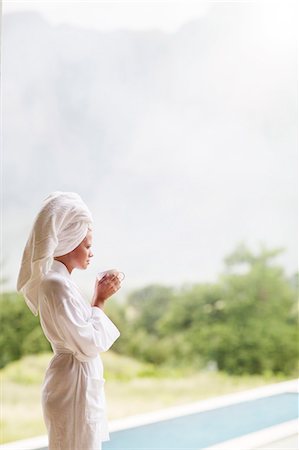 simsearch:6113-07731119,k - Woman in bathrobe drinking coffee outdoors Stock Photo - Premium Royalty-Free, Code: 6113-07731124