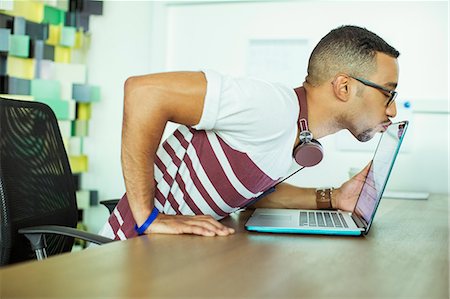 pictures of people working - Man kissing laptop in office Stock Photo - Premium Royalty-Free, Code: 6113-07731497