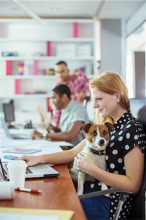 sit man dog - Dog sitting on woman's lap in office Stock Photo - Premium Royalty-Free, Code: 6113-07731435