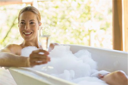Woman having champagne in bubble bath Stock Photo - Premium Royalty-Free, Code: 6113-07731577