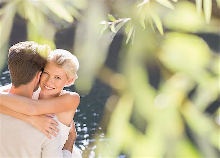 simsearch:6113-07543664,k - Couple hugging by pool Photographie de stock - Premium Libres de Droits, Code: 6113-07731525