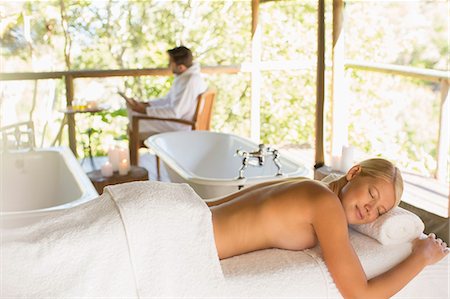 Woman laying on massage table in spa Stock Photo - Premium Royalty-Free, Code: 6113-07731538