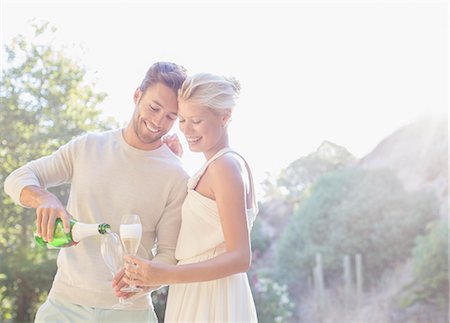 simsearch:6113-07790495,k - Couple drinking champagne outdoors Stock Photo - Premium Royalty-Free, Code: 6113-07731641