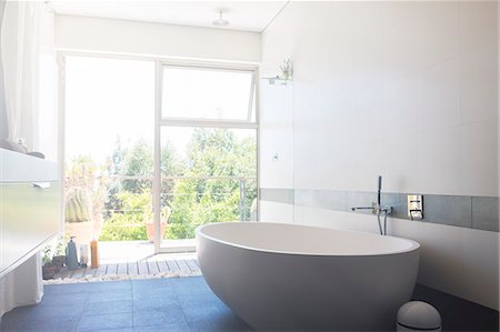 picture in bathroom - Modern bathroom with large white bathtub and patio door Stock Photo - Premium Royalty-Free, Code: 6113-07808175