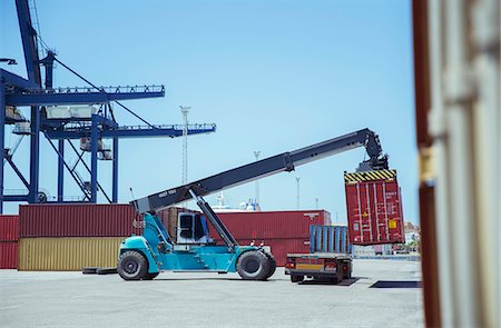 Crane lifting cargo container onto truck Stock Photo - Premium Royalty-Free, Code: 6113-07808363