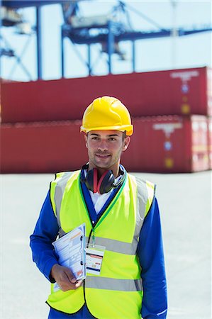 storage compartment - Worker carrying clipboard near cargo containers Stock Photo - Premium Royalty-Free, Code: 6113-07808383