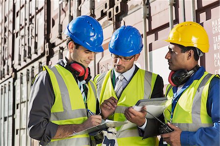 Businessmen and worker talking near cargo containers Stock Photo - Premium Royalty-Free, Code: 6113-07808329