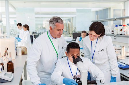 simsearch:6113-07589192,k - Scientists using microscope in laboratory Stock Photo - Premium Royalty-Free, Code: 6113-07808456