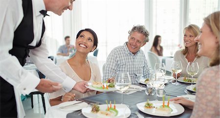 restaurant service - Waiter serving fancy dish to woman sitting at restaurant table Stock Photo - Premium Royalty-Free, Code: 6113-07808586