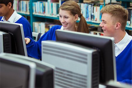 Smiling students working with computers during IT lesson Stock Photo - Premium Royalty-Free, Code: 6113-07961461
